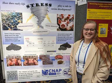 Madeline Hall in front of her research poster